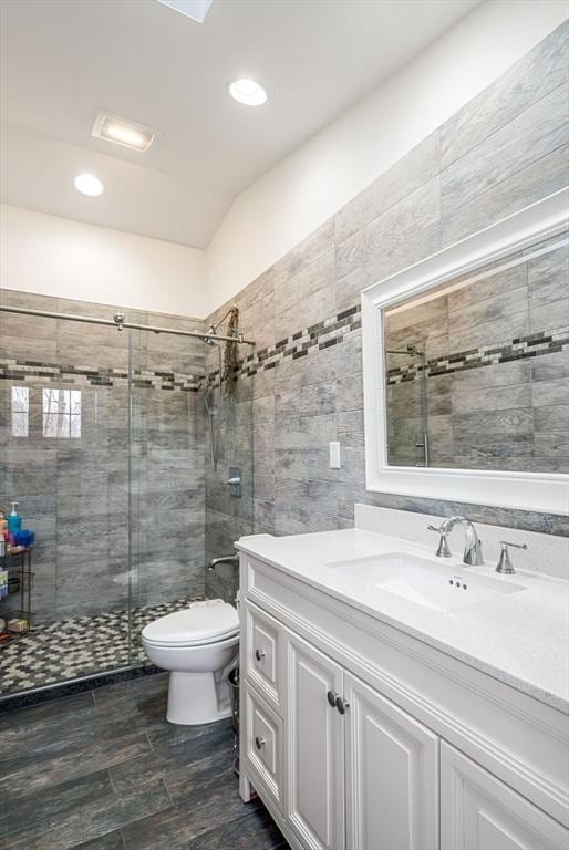 2171 Commonwealth Ave, Newton, MA 02466 - full bathroom with toilet, vanity, a stall shower, recessed lighting, and tile walls