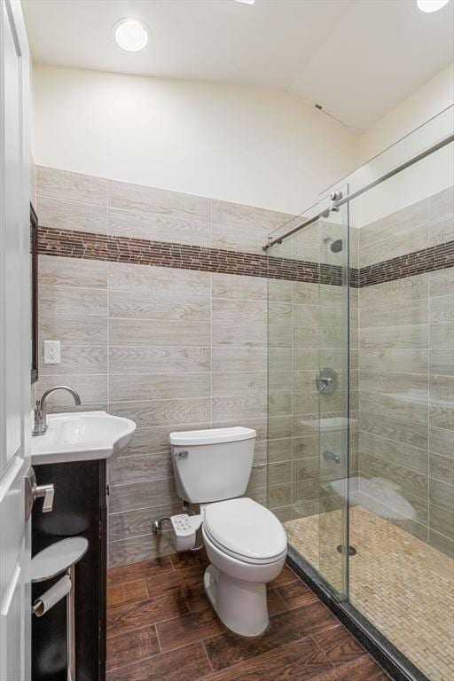 2171 Commonwealth Ave, Newton, MA 02466 - full bath featuring a stall shower, toilet, vanity, wood finished floors, and tile walls