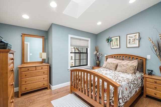 2171 Commonwealth Ave, Newton, MA 02466 - bedroom with wood finished floors, baseboards, a skylight, recessed lighting, and vaulted ceiling
