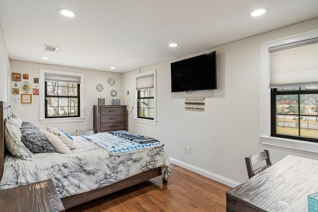 2171 Commonwealth Ave, Newton, MA 02466 - bedroom with wood finished floors, baseboards, recessed lighting, and multiple windows