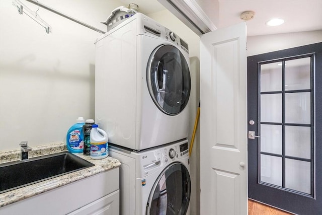 2171 Commonwealth Ave, Newton, MA 02466 - laundry area with estacked washer and dryer and light wood-style flooring