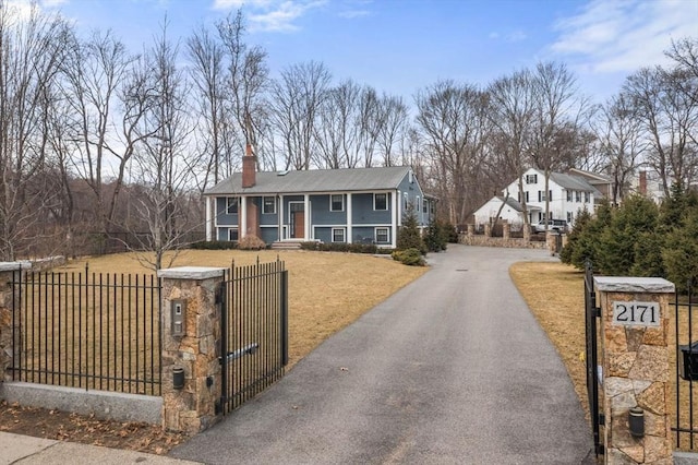2171 Commonwealth Ave, Newton, MA 02466 - split foyer home featuring a chimney, a gate, driveway, and covered porch