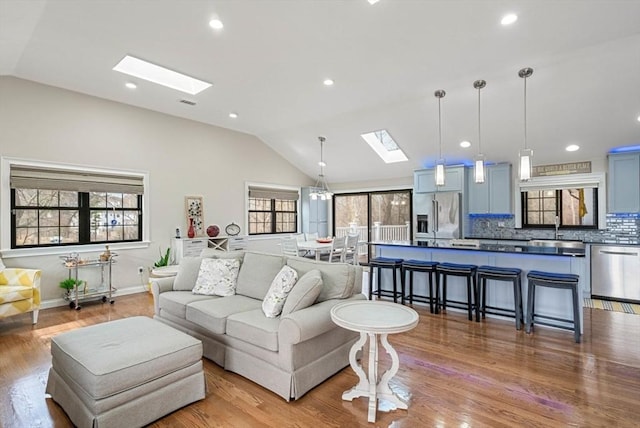 2171 Commonwealth Ave, Newton, MA 02466 - living area with a skylight, lofted ceiling, healthy amount of natural light, wood finished floors, and baseboards