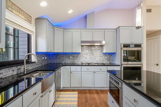 2171 Commonwealth Ave, Newton, MA 02466 - kitchen with lofted ceiling, double oven, light wood finished floors, backsplash, and gas cooktop