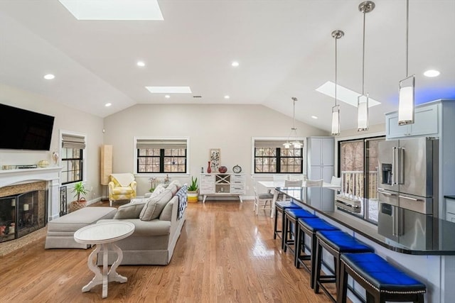 2171 Commonwealth Ave, Newton, MA 02466 - living room with a skylight, lofted ceiling, recessed lighting, a premium fireplace, and light wood-style flooring