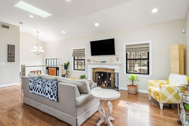 2171 Commonwealth Ave, Newton, MA 02466 - living area with a chandelier, wood finished floors, lofted ceiling, a fireplace, and baseboards