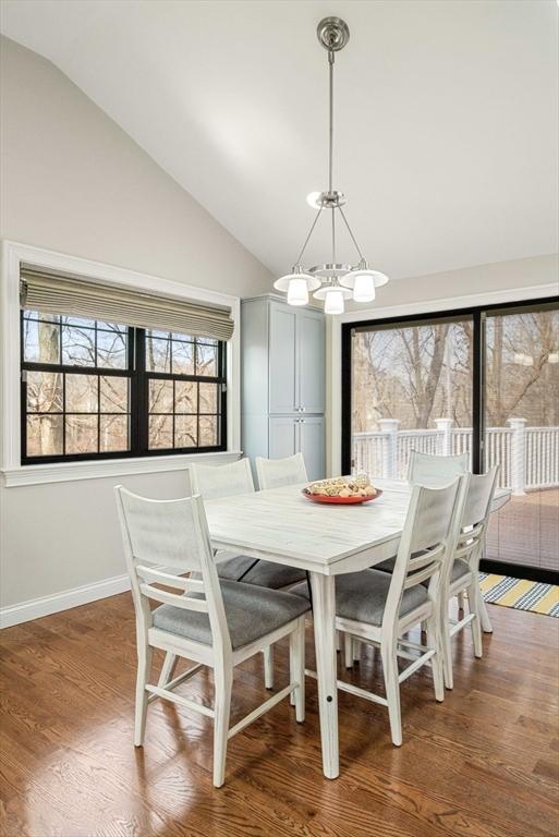 2171 Commonwealth Ave, Newton, MA 02466 - dining room featuring lofted ceiling, a chandelier, plenty of natural light, wood finished floors, and baseboards