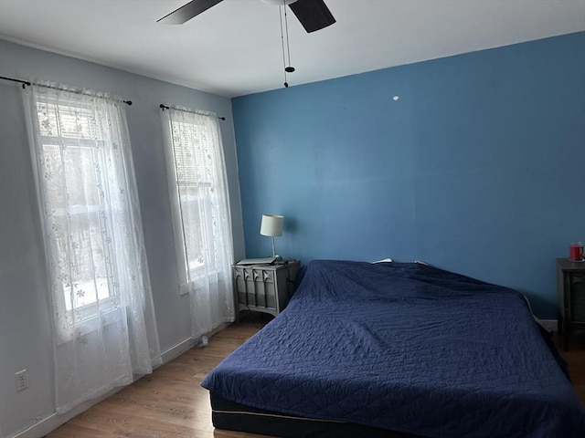 bedroom with ceiling fan and wood finished floors