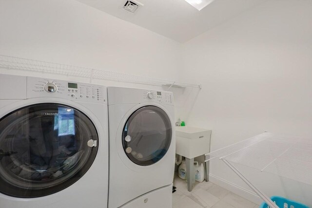 37 Sandy Ridge Rd, Sterling, MA 01564 - laundry room with washer and dryer, light marble finish flooring, and baseboards