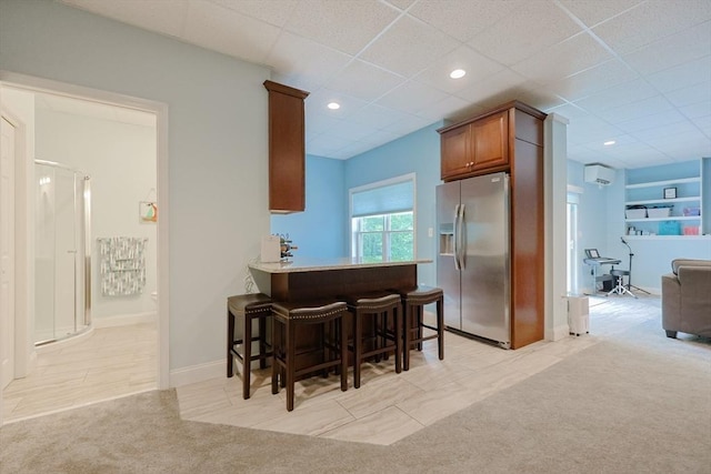 37 Sandy Ridge Rd, Sterling, MA 01564 - kitchen featuring stainless steel fridge with ice dispenser, light colored carpet, a breakfast bar, brown cabinets, and baseboards