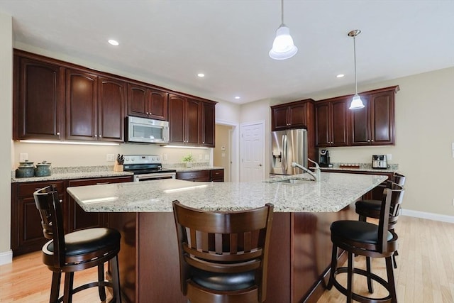 37 Sandy Ridge Rd, Sterling, MA 01564 - kitchen with stainless steel appliances, a sink, baseboards, light wood-style floors, and recessed lighting