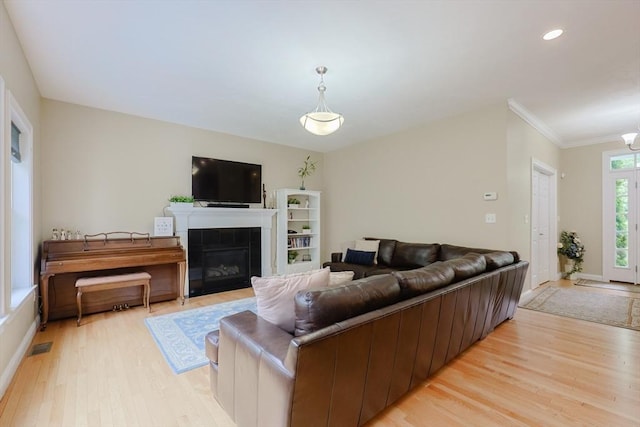 37 Sandy Ridge Rd, Sterling, MA 01564 - living area with light wood-style flooring, a tile fireplace, ornamental molding, baseboards, and recessed lighting