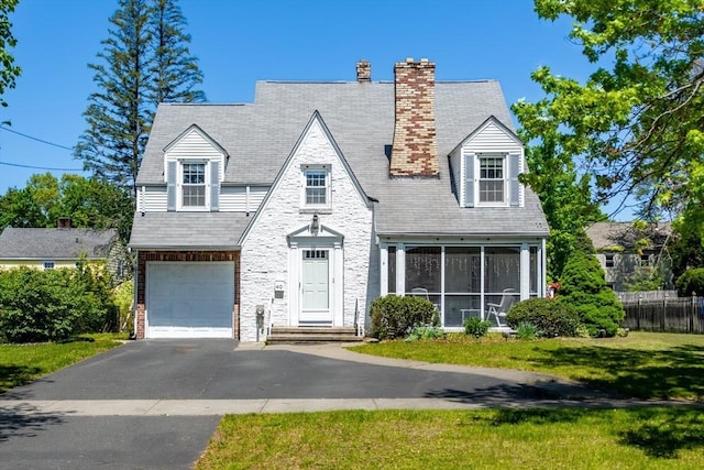 40 Fenimore Blvd, Springfield, MA 01108 - view of front of home with asphalt driveway, a garage, a sunroom, stone siding, and a chimney