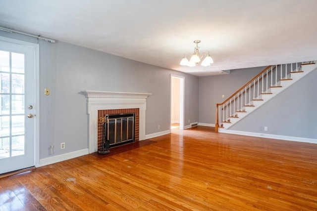 40 Fenimore Blvd, Springfield, MA 01108 - unfurnished living room featuring wood finished floors, stairs, a chandelier, and baseboards