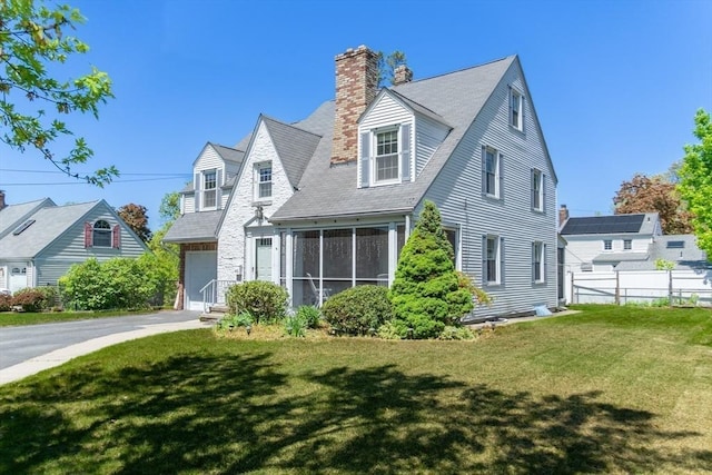 40 Fenimore Blvd, Springfield, MA 01108 - cape cod house with a chimney, a sunroom, and asphalt driveway
