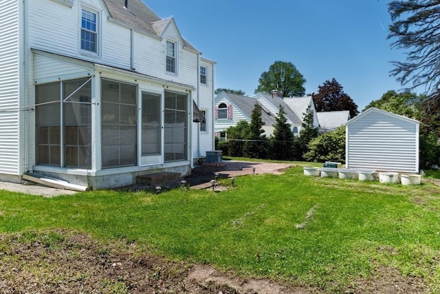 40 Fenimore Blvd, Springfield, MA 01108 - view of grassy yard with a sunroom and central AC
