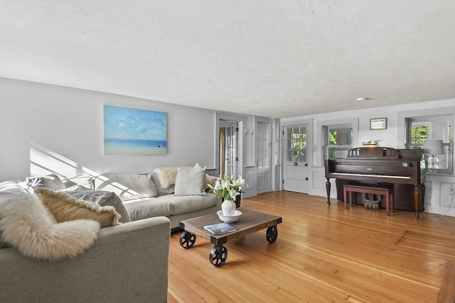 living room with hardwood / wood-style floors and a textured ceiling