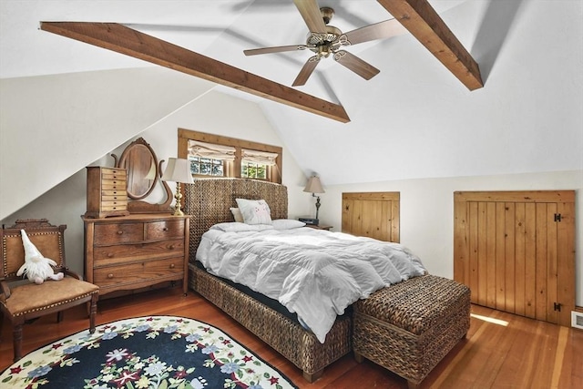 bedroom with a ceiling fan, lofted ceiling with beams, wood finished floors, and visible vents