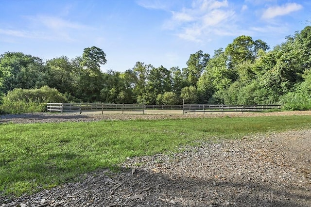 view of yard with a rural view and fence