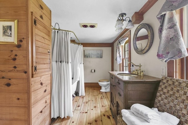 bathroom featuring curtained shower, toilet, vanity, and hardwood / wood-style floors