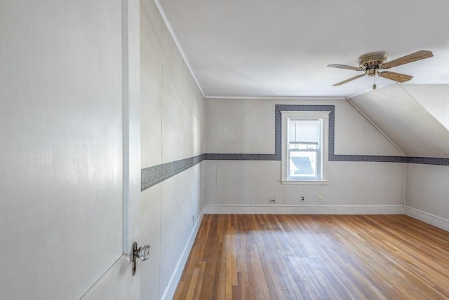 additional living space with ceiling fan, vaulted ceiling, baseboards, and hardwood / wood-style flooring