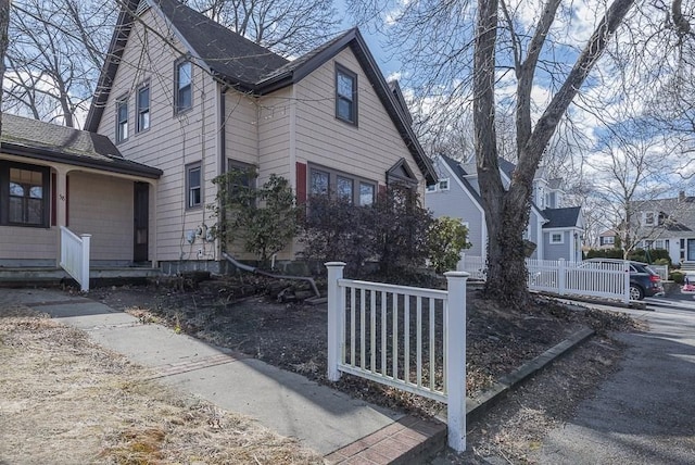 view of side of home featuring fence