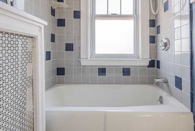 bathroom featuring walk in shower, a bathing tub, and a wealth of natural light