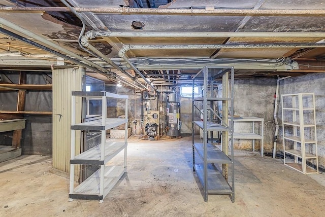 basement featuring water heater and a heating unit