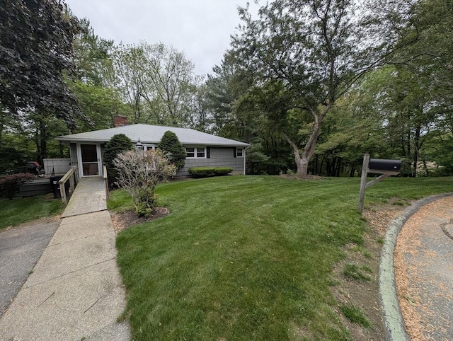17 Laurel Dr, Millbury, MA 01527 - view of front of property with a front lawn, a chimney, and view of scattered trees