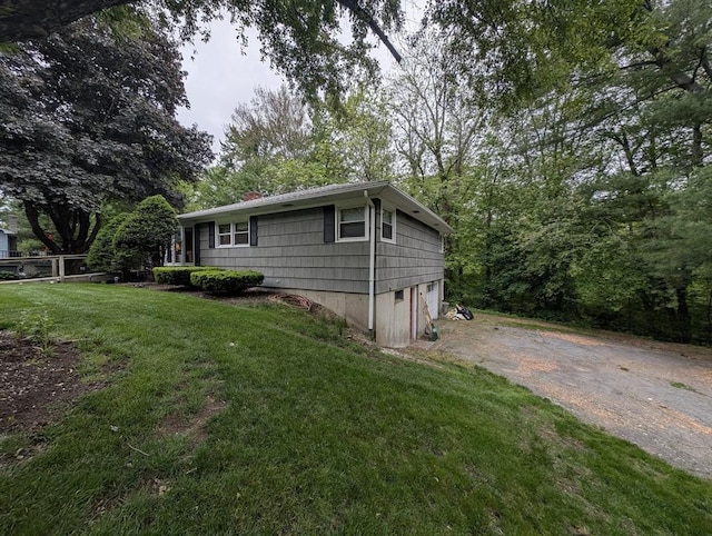 17 Laurel Dr, Millbury, MA 01527 - view of side of home featuring dirt driveway, a lawn, a chimney, and a garage