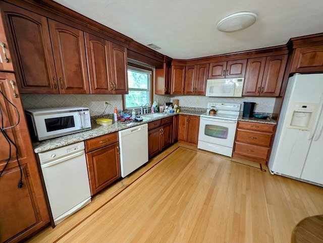 17 Laurel Dr, Millbury, MA 01527 - kitchen with white appliances, light wood-type flooring, a sink, decorative backsplash, and light stone counters