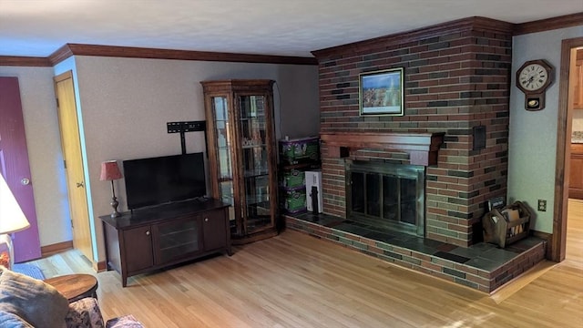 17 Laurel Dr, Millbury, MA 01527 - living area featuring crown molding, wood finished floors, a fireplace, and baseboards