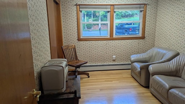 17 Laurel Dr, Millbury, MA 01527 - living area with a baseboard radiator, wallpapered walls, wood finished floors, and baseboards