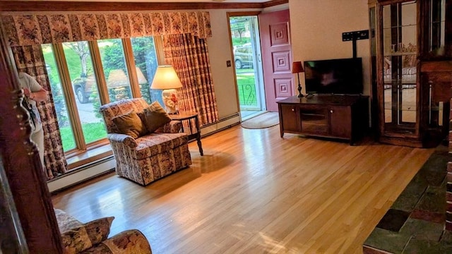 17 Laurel Dr, Millbury, MA 01527 - living area with a baseboard heating unit, wood finished floors, and healthy amount of natural light