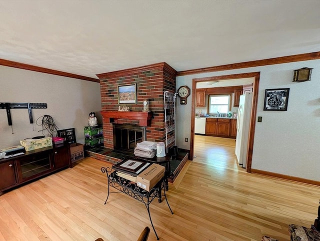 17 Laurel Dr, Millbury, MA 01527 - living area with crown molding, a fireplace, light wood-style flooring, and baseboards