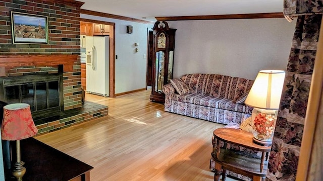 17 Laurel Dr, Millbury, MA 01527 - living area featuring ornamental molding, light wood-style floors, baseboards, and a brick fireplace