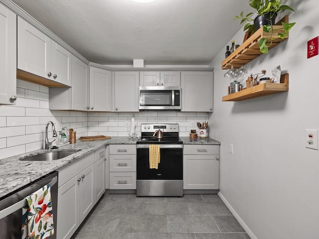 14 Riverside Dr, North Reading, MA 01864 - kitchen with stainless steel appliances, a sink, tasteful backsplash, and light stone countertops