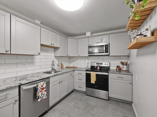 14 Riverside Dr, North Reading, MA 01864 - kitchen with stainless steel appliances, a sink, decorative backsplash, and light stone countertops