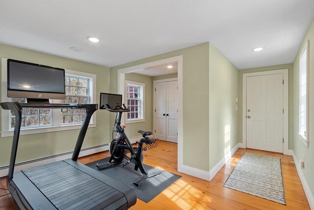 workout area with recessed lighting, wood finished floors, and baseboards