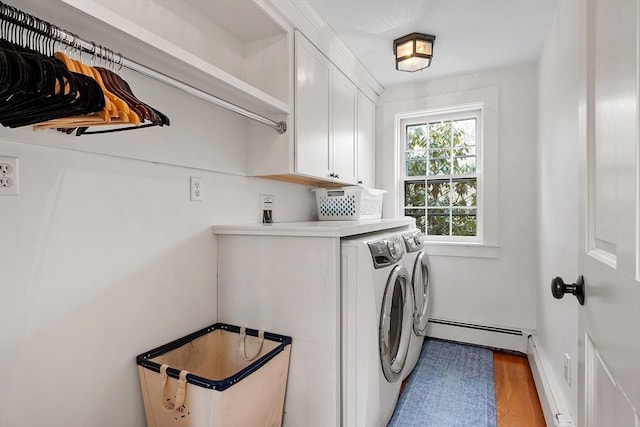 laundry room with a baseboard radiator, cabinet space, separate washer and dryer, and wood finished floors