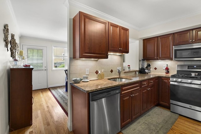 2826 Washington St, Boston, MA 02119 - kitchen with appliances with stainless steel finishes, a sink, light wood-style floors, stone counters, and backsplash