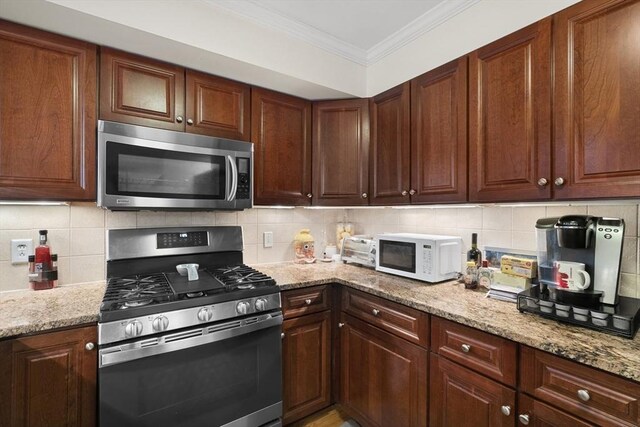 2826 Washington St, Boston, MA 02119 - kitchen with stainless steel appliances, tasteful backsplash, ornamental molding, and light stone countertops