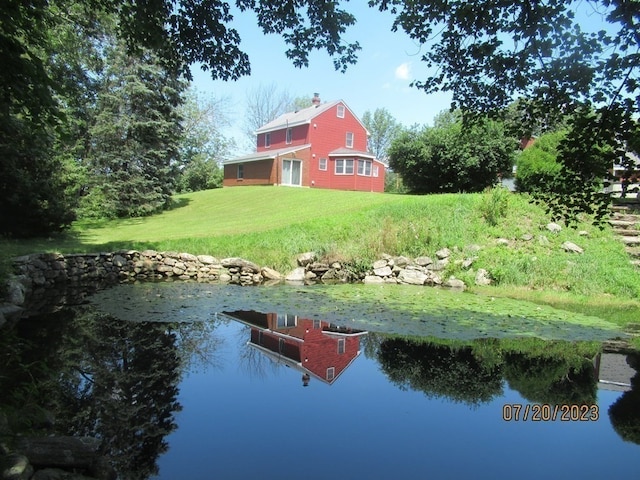 exterior space featuring a yard and a water view