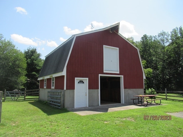 view of outdoor structure featuring a lawn