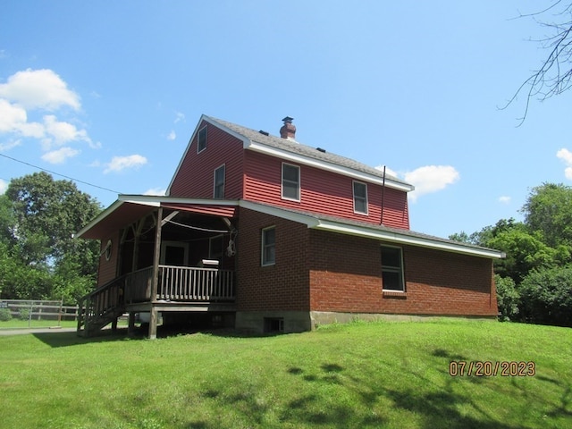 back of property featuring a yard