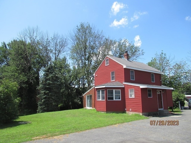 view of side of property with a yard