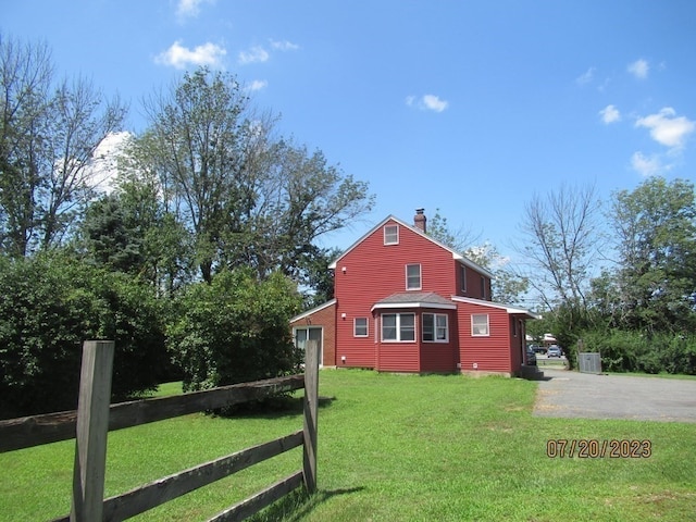 view of property exterior featuring a yard