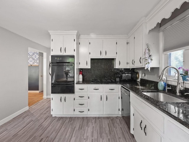 20 Dunshire Dr, Chelmsford, MA 01863 - kitchen featuring black appliances, a warming drawer, white cabinetry, light wood-type flooring, and dark stone countertops