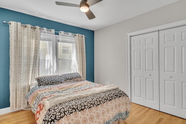 bedroom featuring a ceiling fan, a closet, and wood finished floors