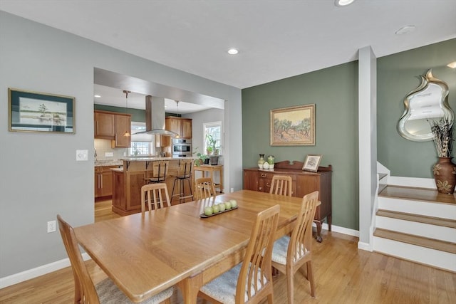 dining space with stairway, baseboards, recessed lighting, and light wood-style flooring